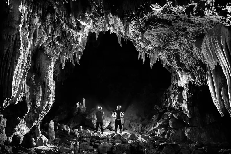 Cave formations lit by headlamps