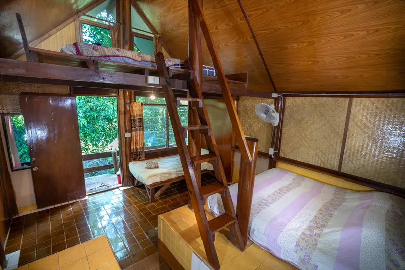 Bungalow with a ladder up to a sleeping loft
